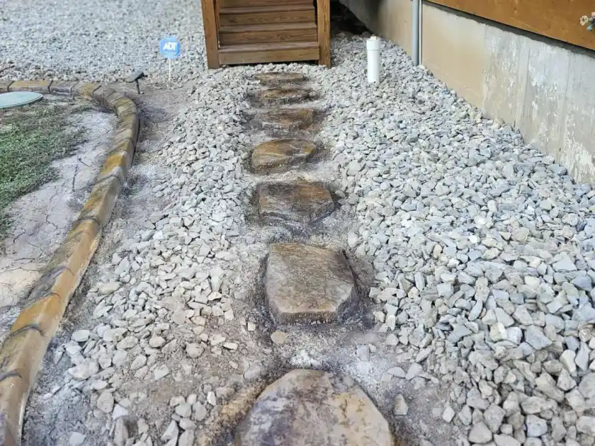 Concrete curbing around a small commercial storefront landscape bed