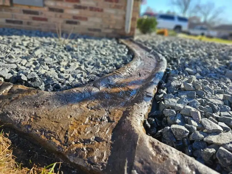 Handcrafted decorative concrete downspout drainage channel with river rock
