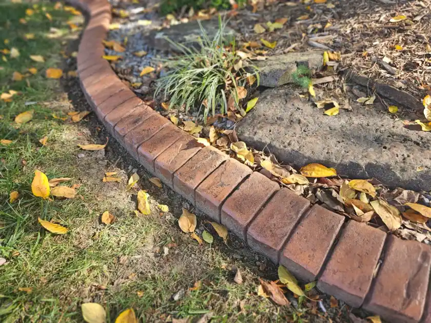 Farmhouse brick pattern concrete curbing along a garden bed