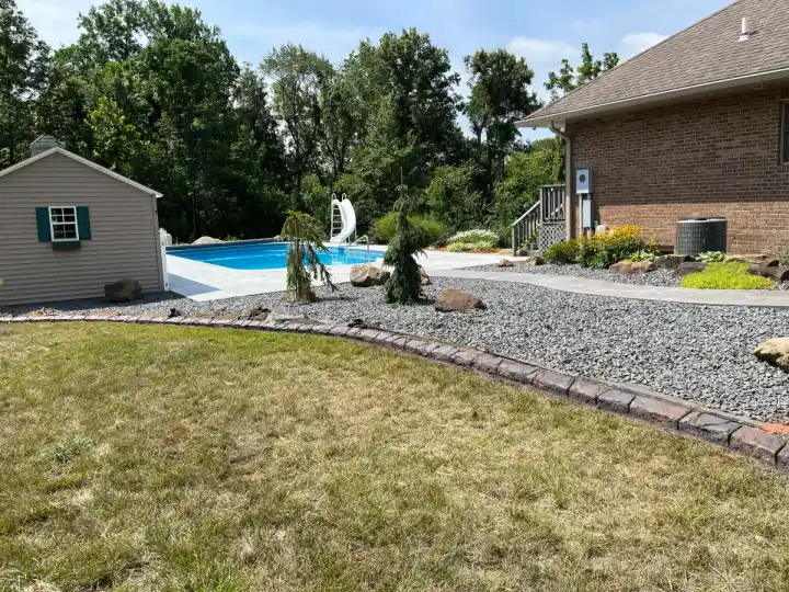 Farmhouse brick concrete curbing installed beside a driveway