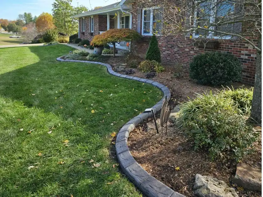 Decorative concrete curbing around a finished front yard landscape