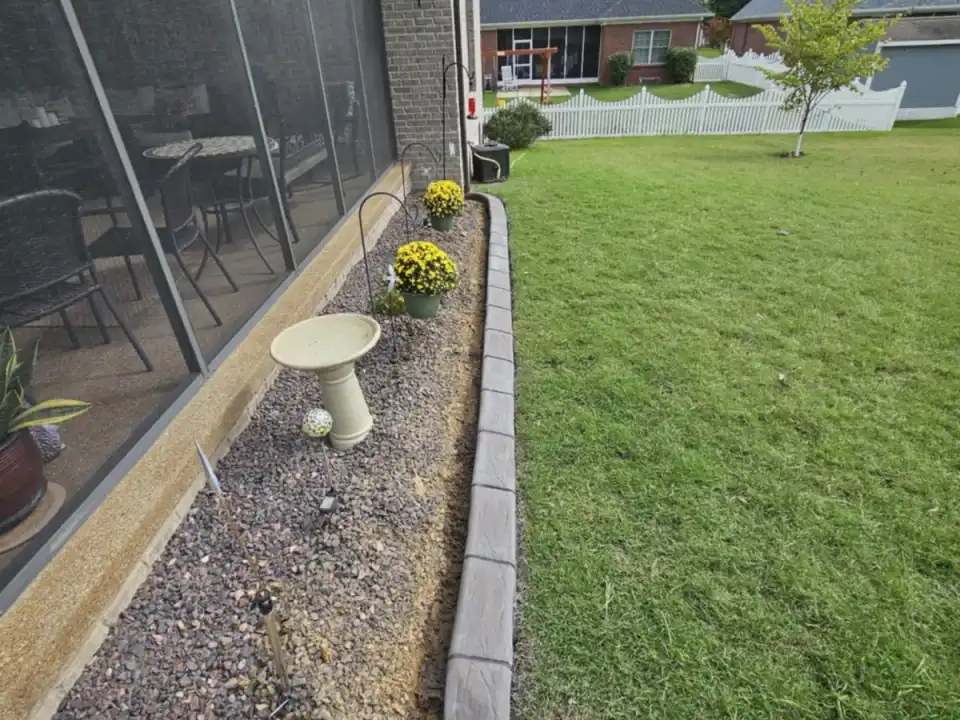 Straight gray concrete curbing along a screened residential patio