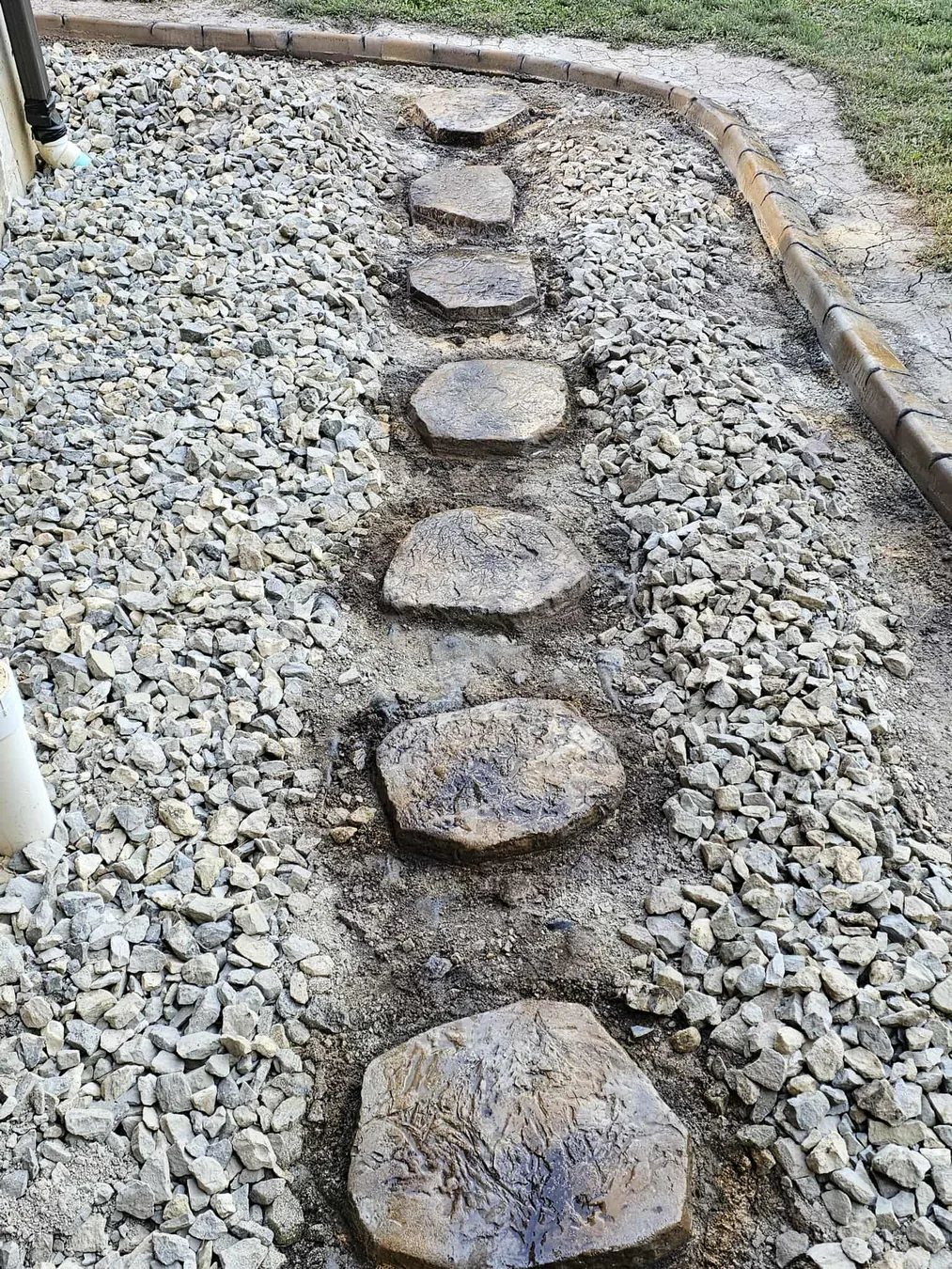 Stryker crew installing curbing and custom stepping stones