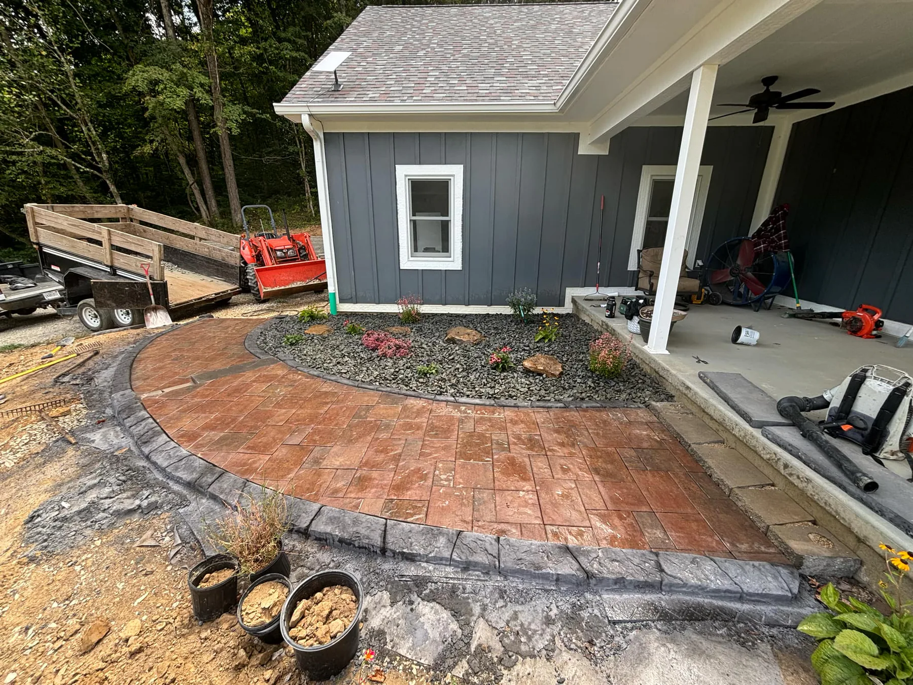 Freshly formed concrete border around a new patio area