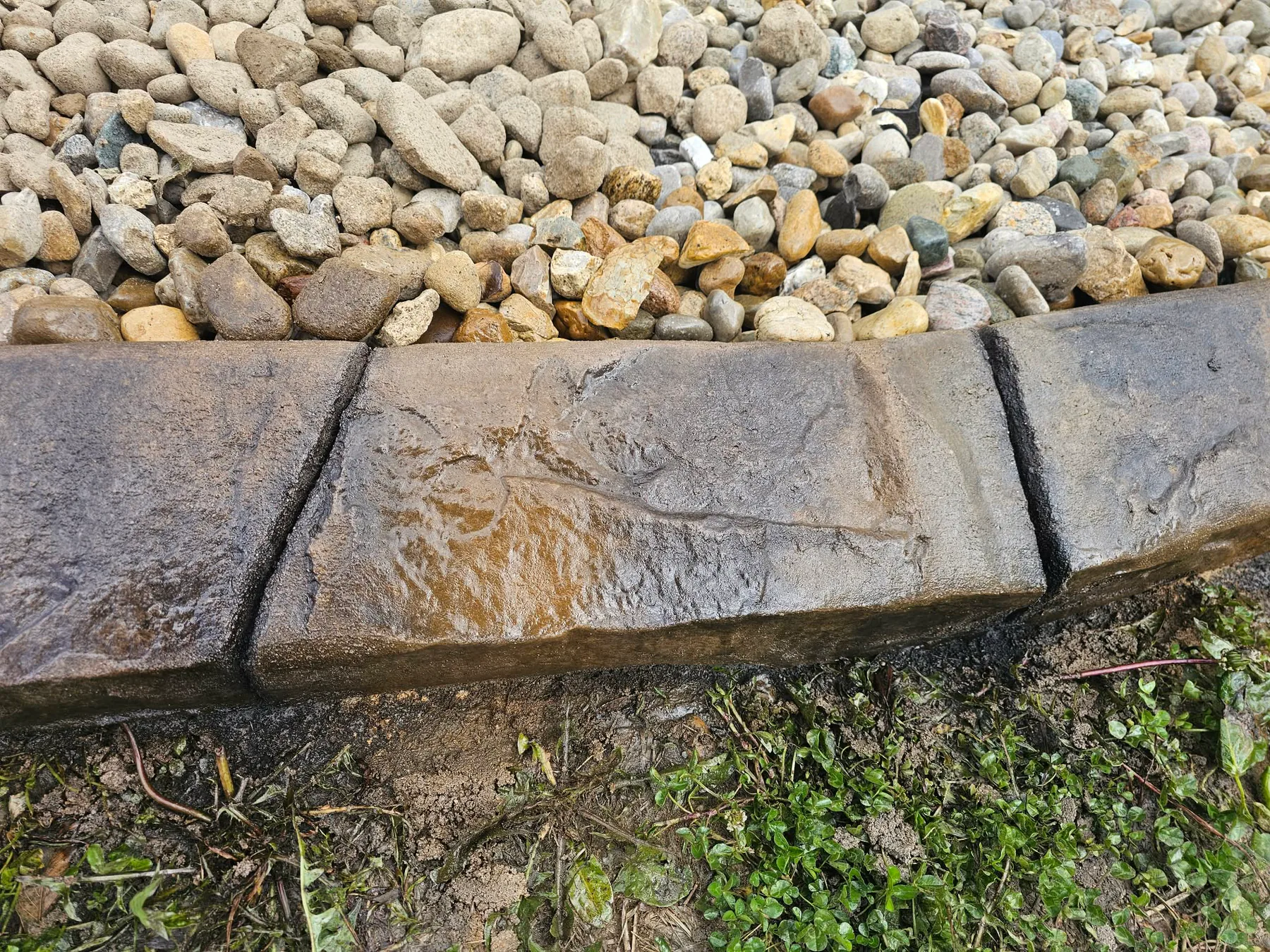 Close view of a two-tone stamped concrete curb profile