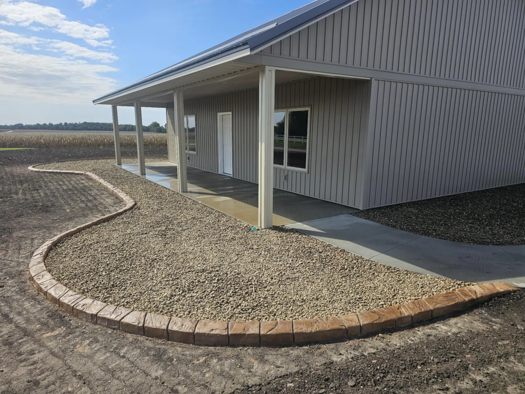 Completed stamped concrete edging around a covered patio