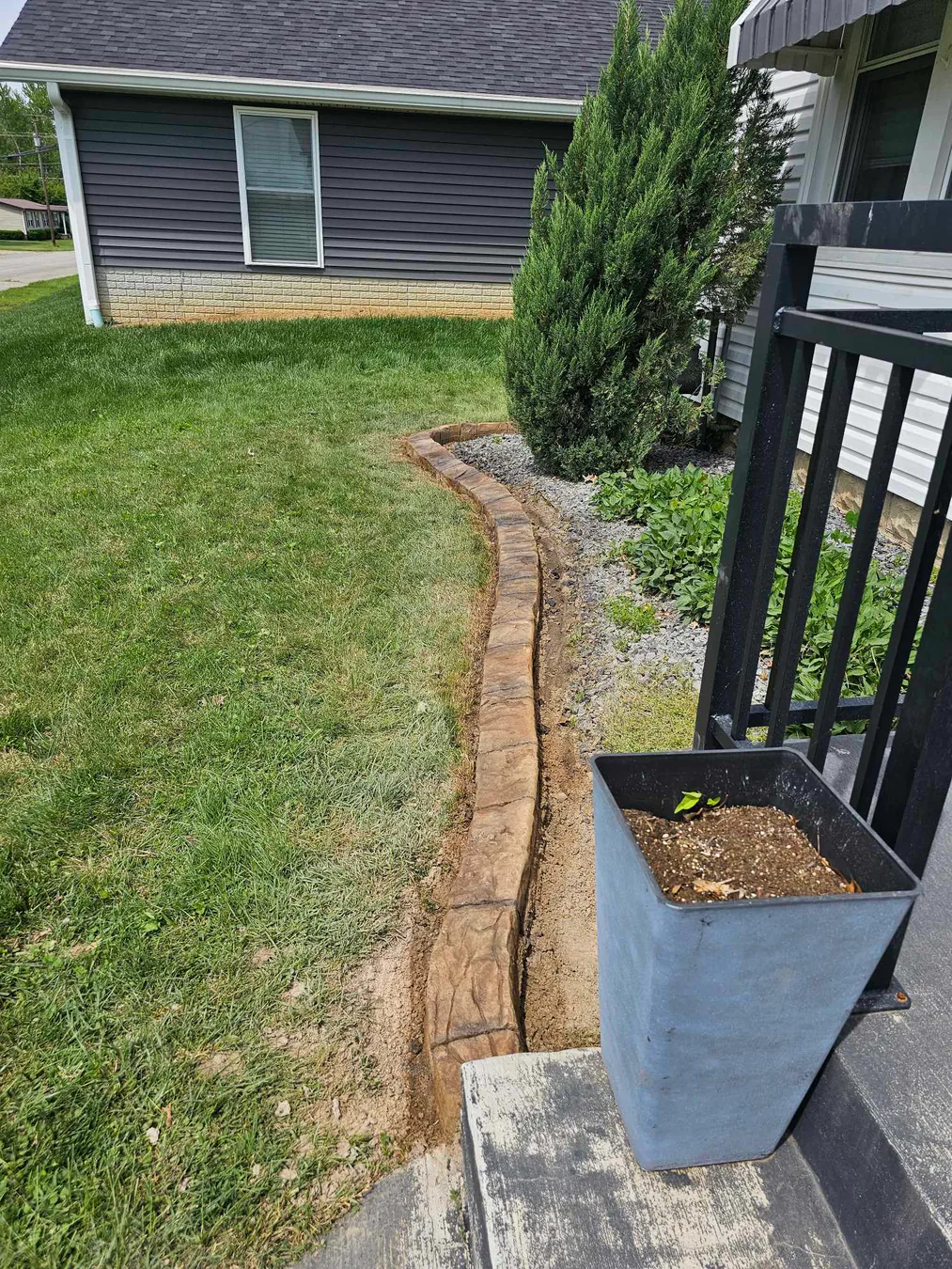 Long narrow view of textured concrete landscape curbing