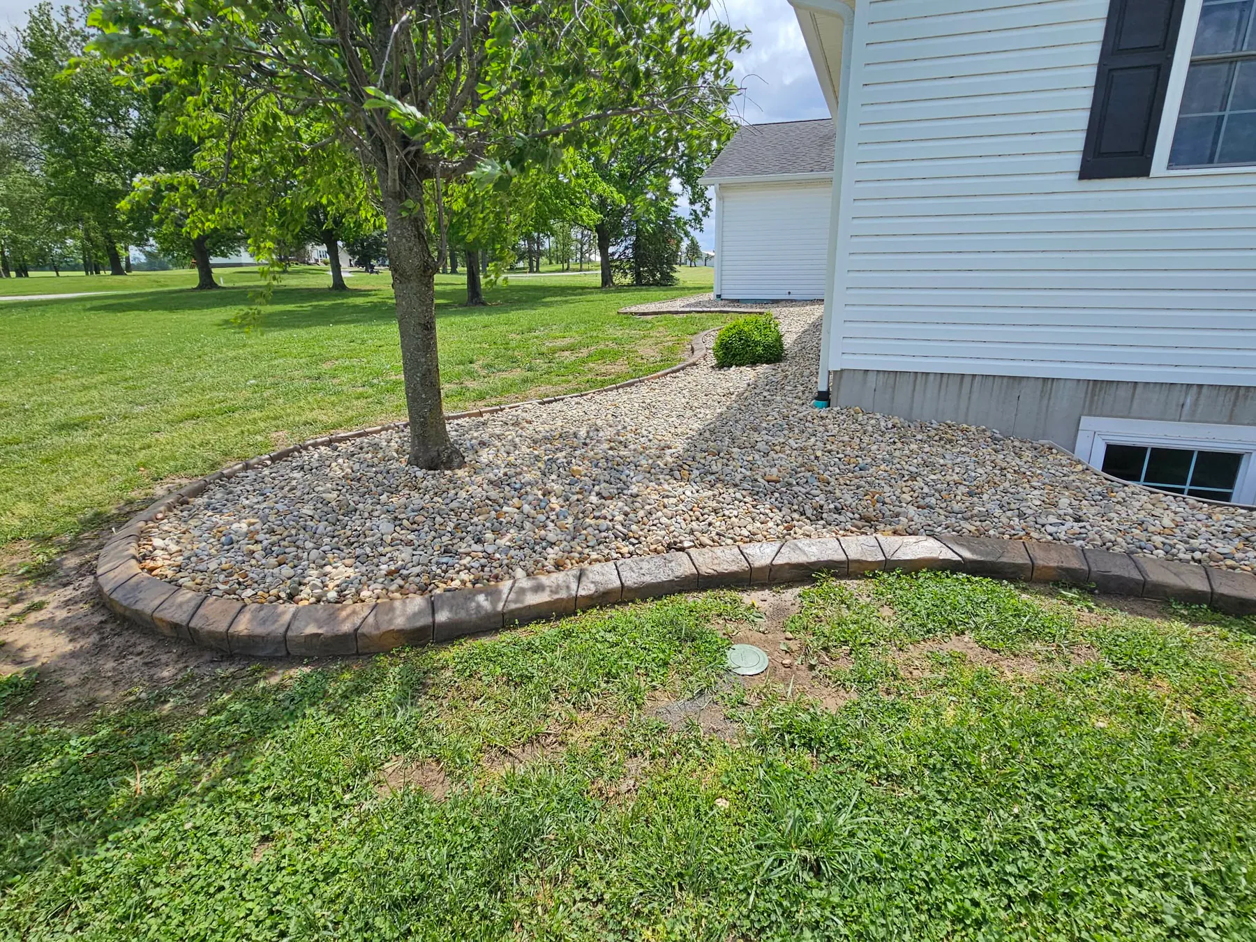 Circular decorative concrete curb around a young tree