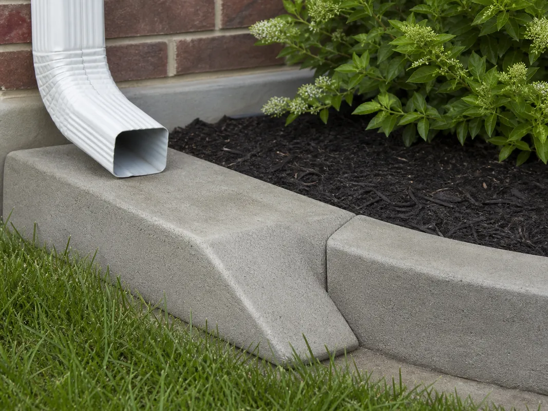 handcrafted downspout extension matching concrete curbing in Southern Indiana