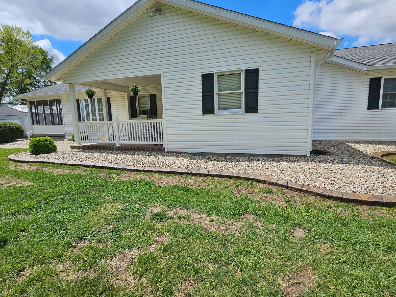 Farmhouse-brick concrete curbing around a front foundation bed