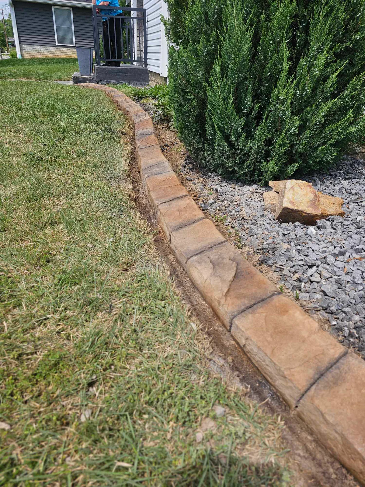 Close view of natural-stone concrete curbing texture and color variation