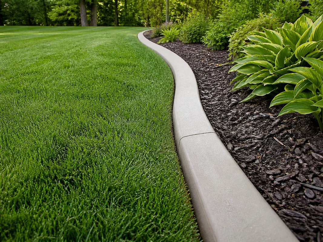concrete curbing separating lawn and planting bed in Bloomington Indiana