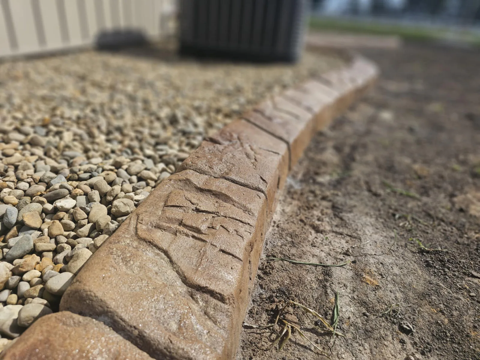 Close view of the color and texture on stamped concrete curbing
